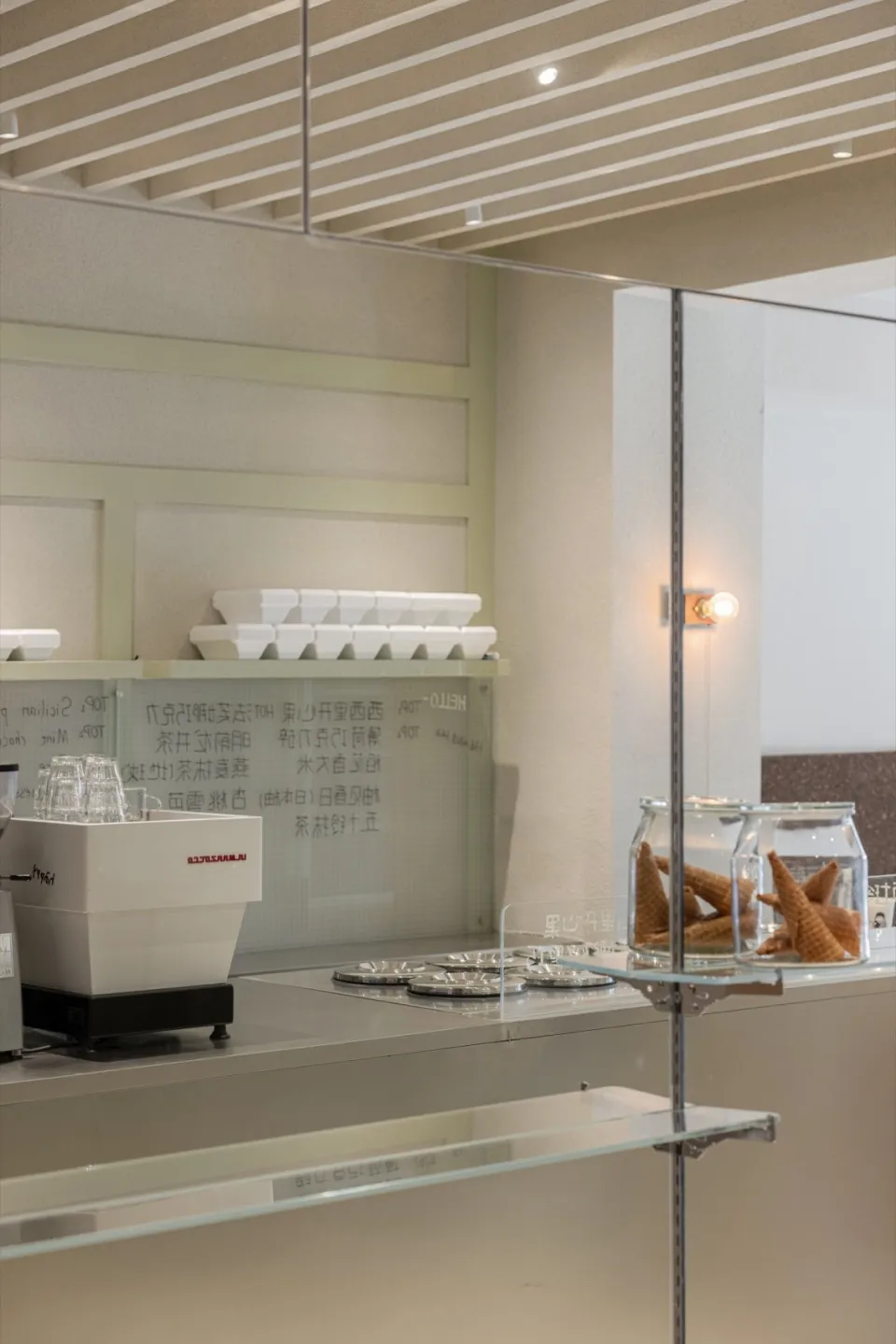 A casual restaurant counter with displayed food, cups, and bottles, set in a welcoming atmosphere