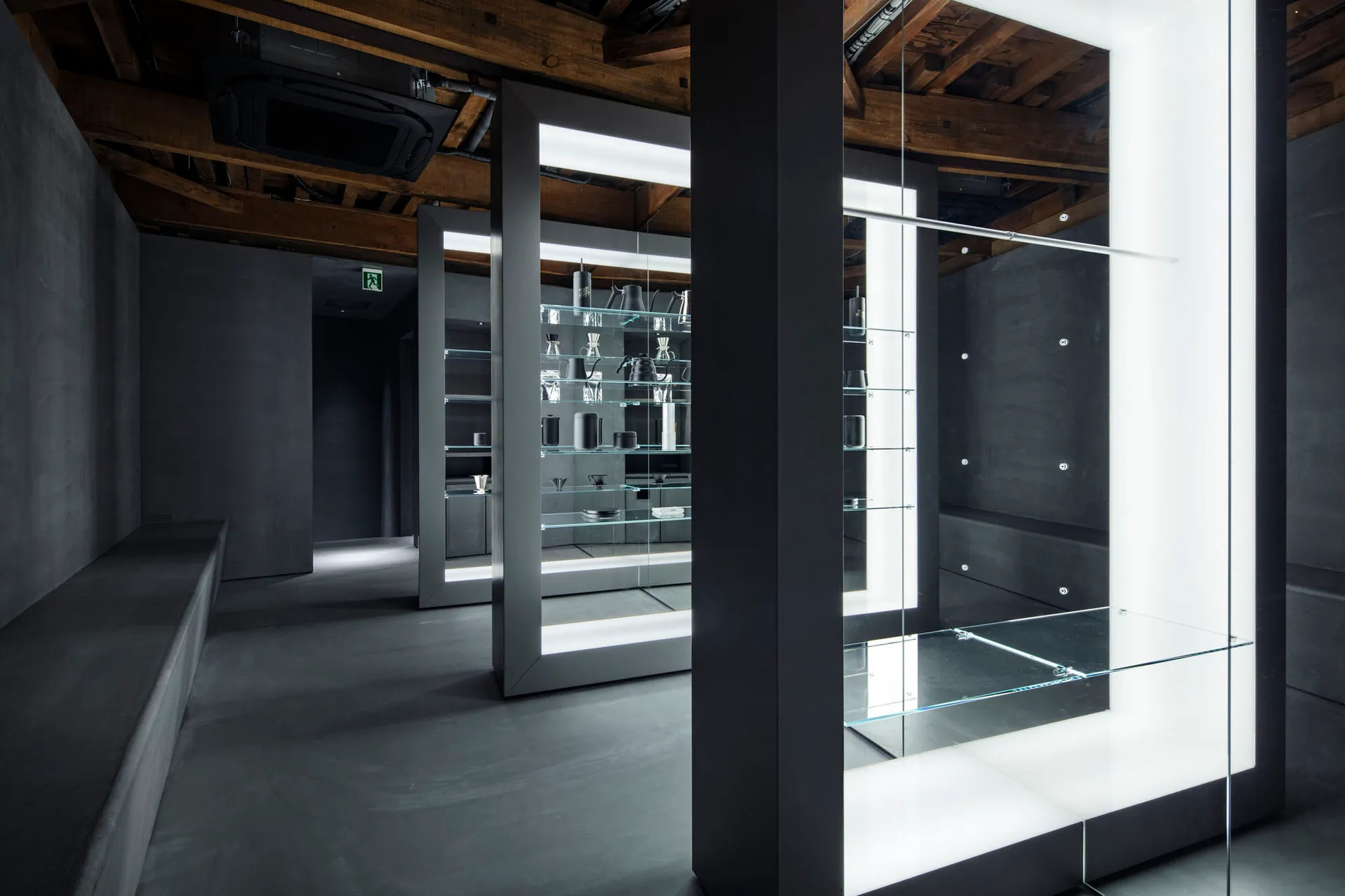 Empty bathroom with a large mirror on one wall, reflecting the surrounding area and creating a sense of depth