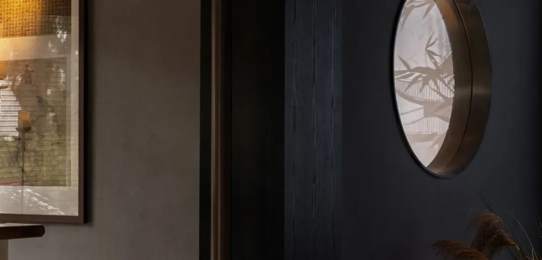 A dark hallway with two mirrors on the walls above a doorway, creating a sense of mystery