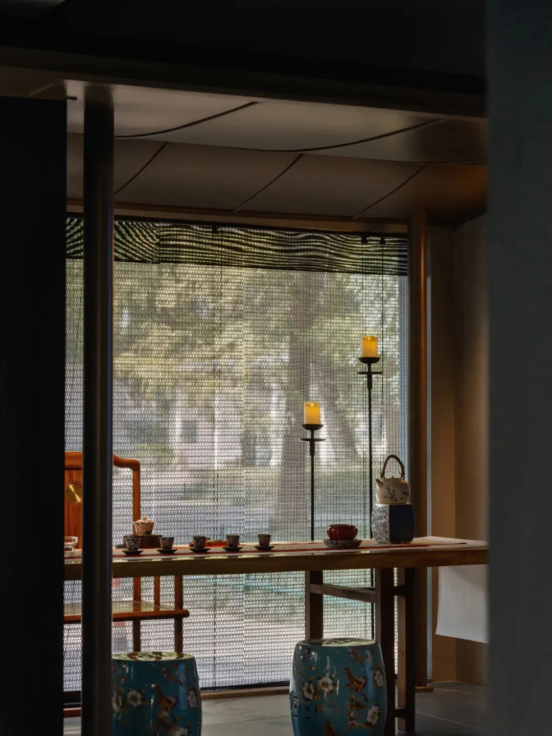 Cozy traditional living and dining space with a wooden dining table, chairs, and classic furnishings, dimly lit