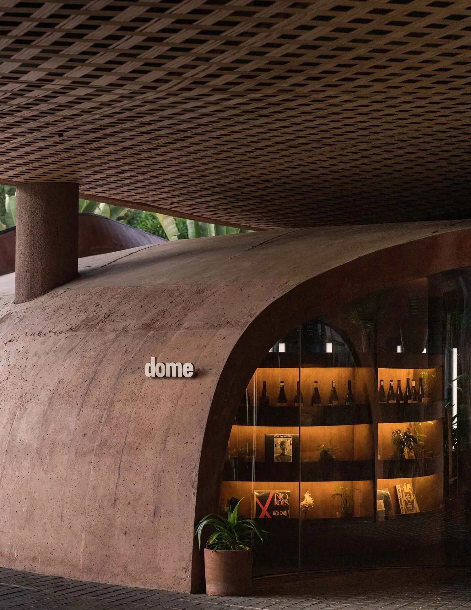 A wine store interior with a glass case displaying wine bottles and a dome structure, conveying a sophisticated ambiance