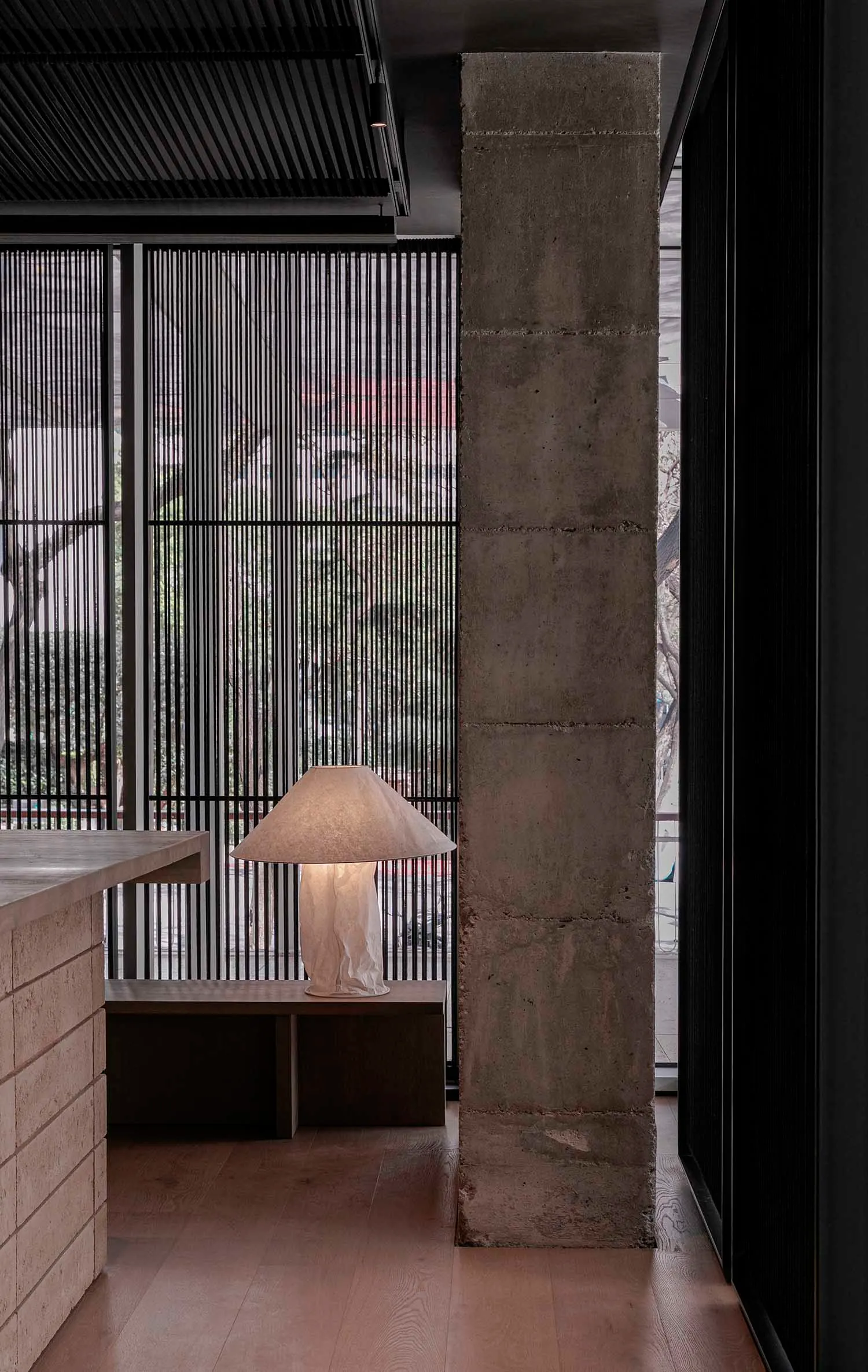 Cozy living area with a couch in front of a window, lamps, and a dining table, with natural light pouring in