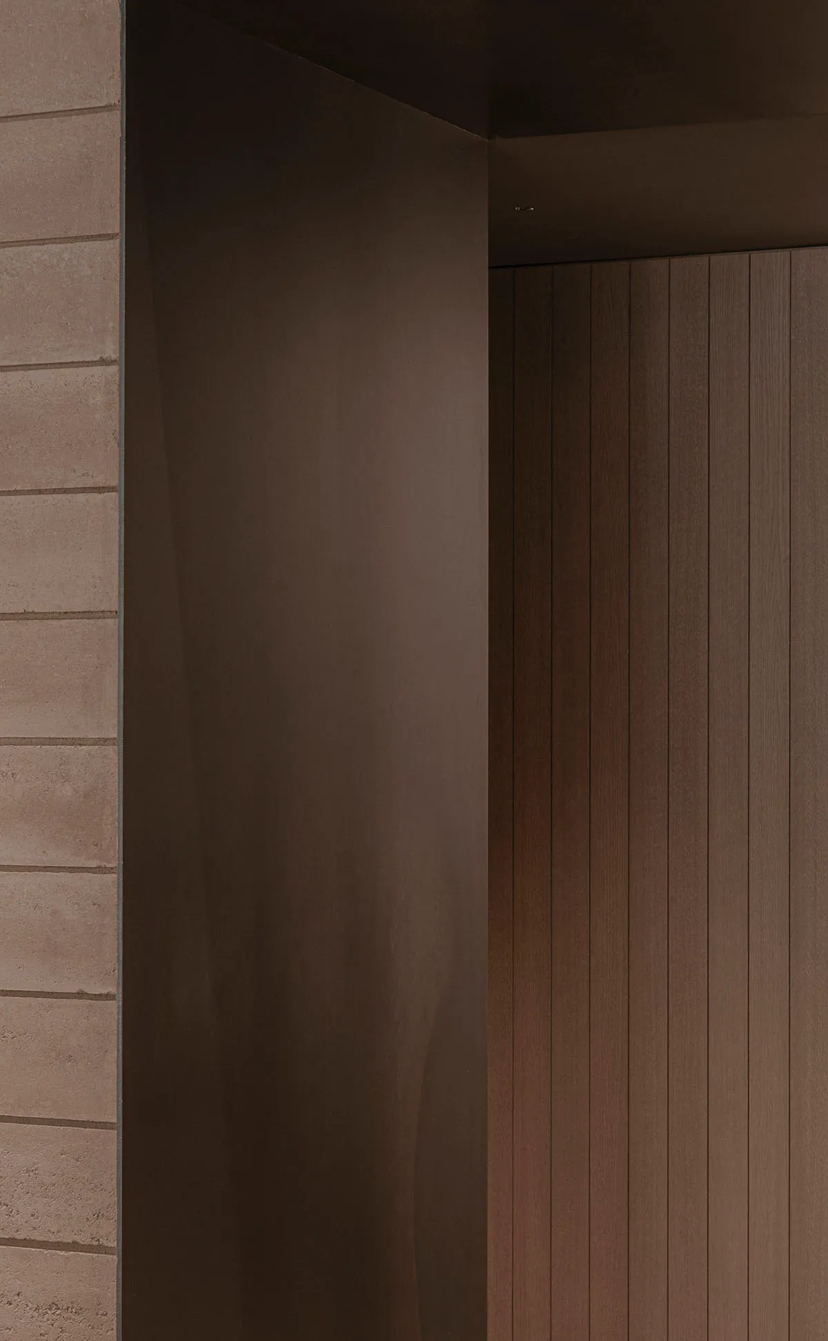 A wooden doorway with a brown frame leads to a darker area beyond, creating a sense of mystery