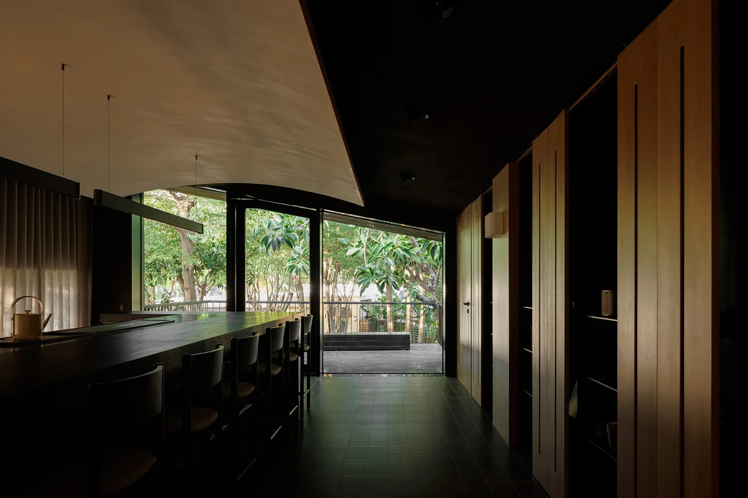 Cozy restaurant with black and white theme, modern seating, and natural light from a large window