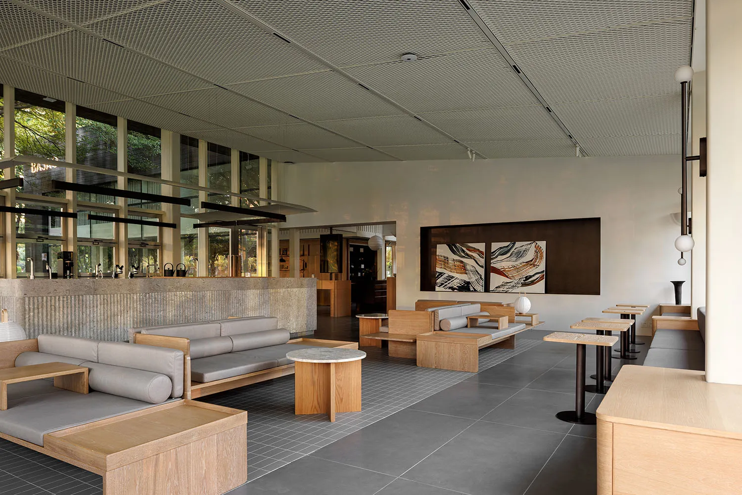 Open living area with modern furniture, neutral tones, and natural light from windows