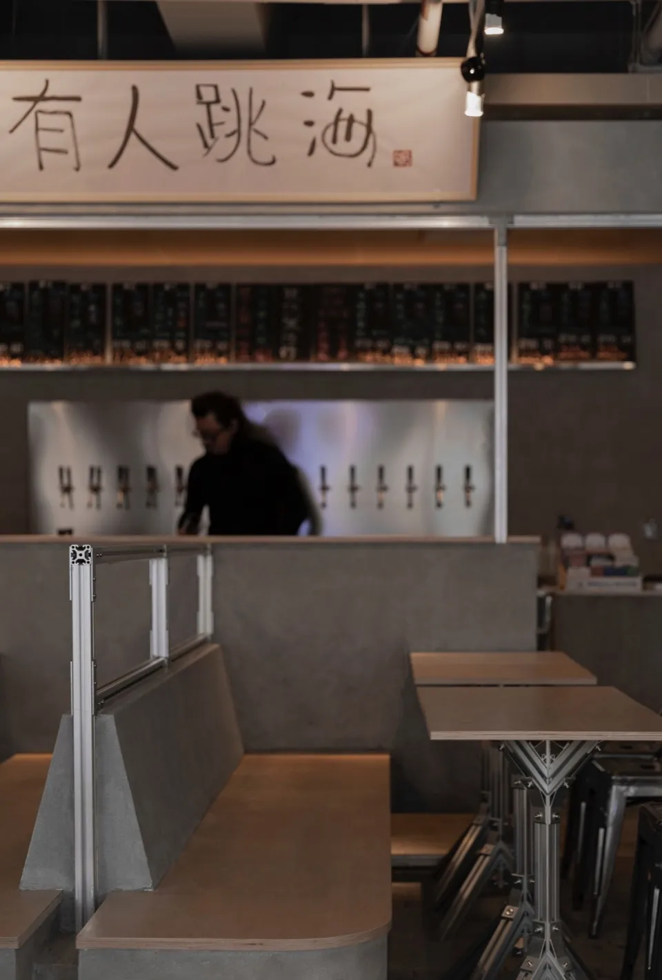 Casual restaurant interior with a bar area, dining tables, and comfortable seating for patrons