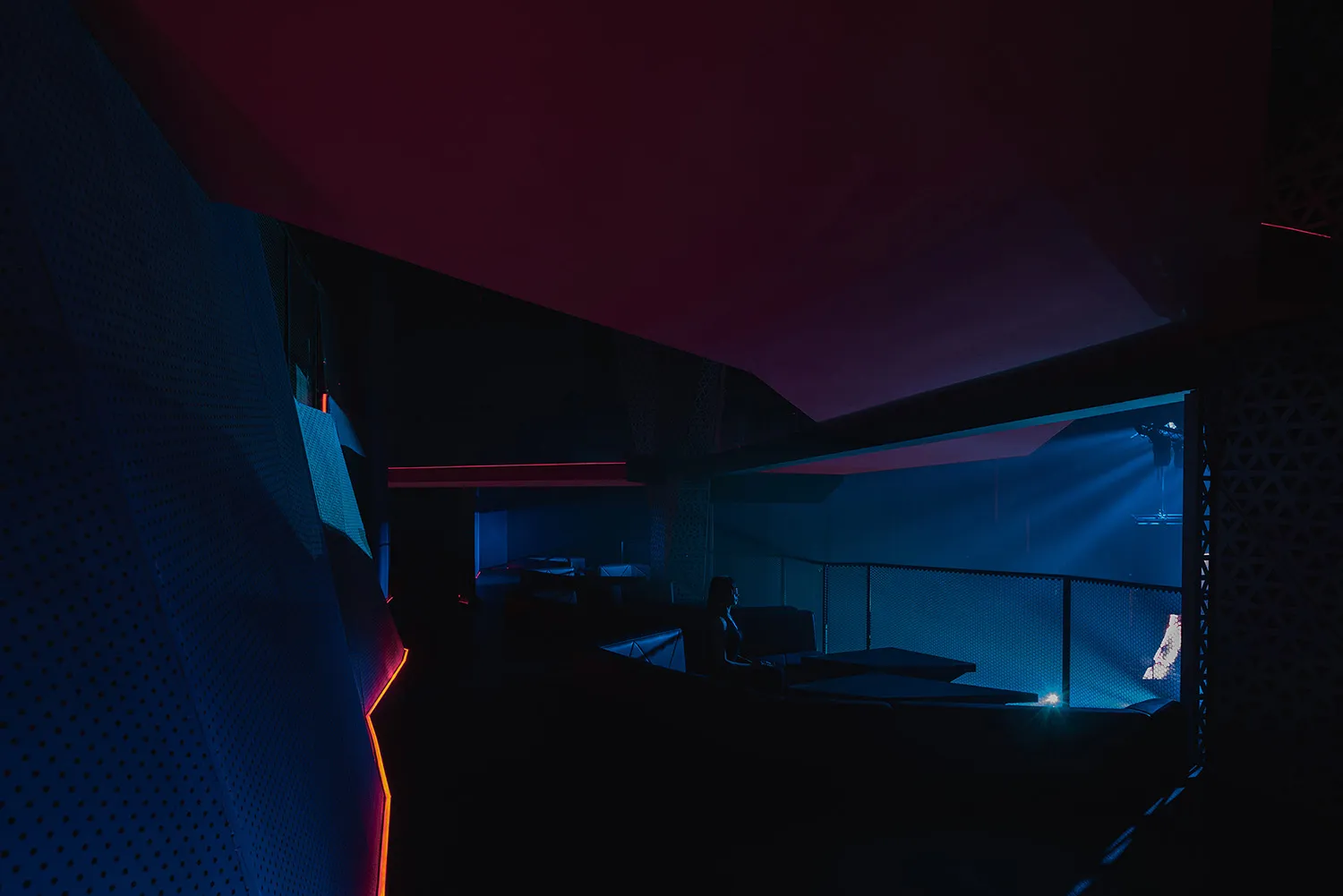 A social indoor bar lounge with red accent walls, comfortable seating, and a relaxed atmosphere