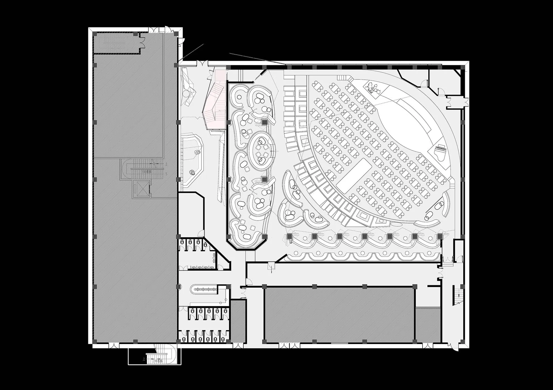 A large auditorium with multiple rows of chairs, a black and white color scheme, and a spacious and inviting atmosphere