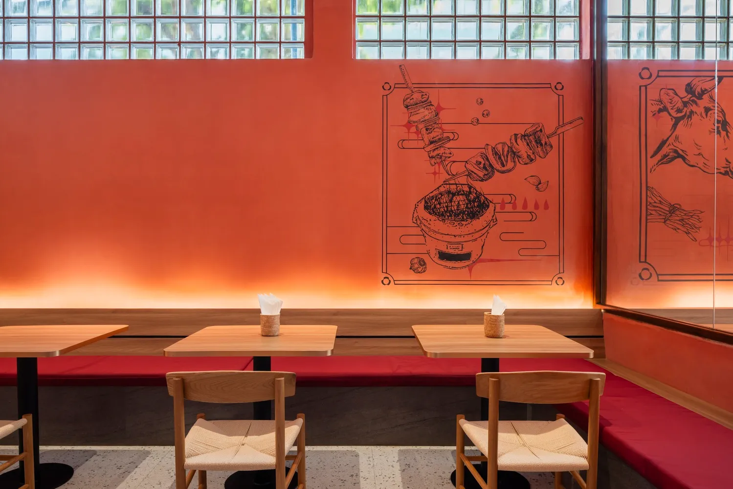 Warm and inviting Asian restaurant interior with wooden tables and chairs, a bowl on one table, and a cozy atmosphere