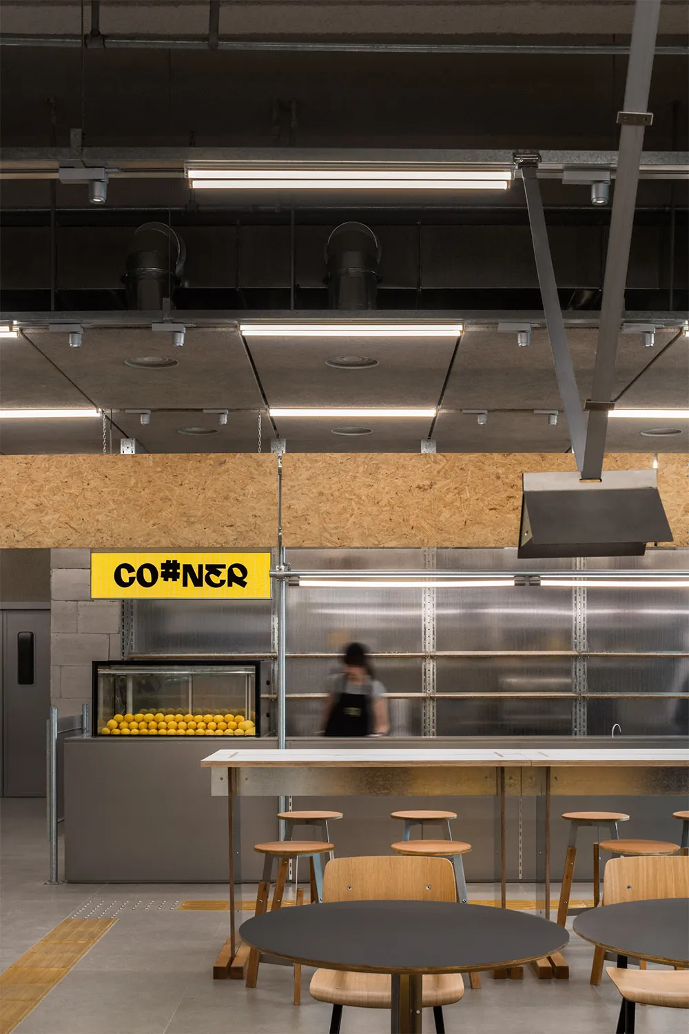 Inviting restaurant kitchen with a counter and chairs, bottles, and a focus on functionality and convenience