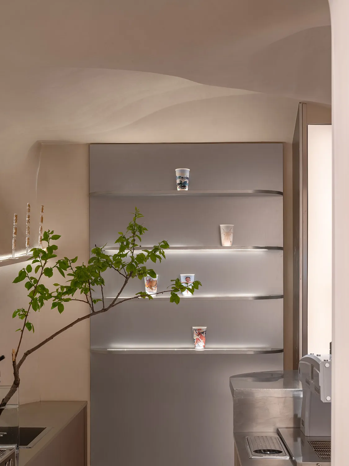 Clean and organized bathroom with a toilet and sink, featuring shelves and bottles