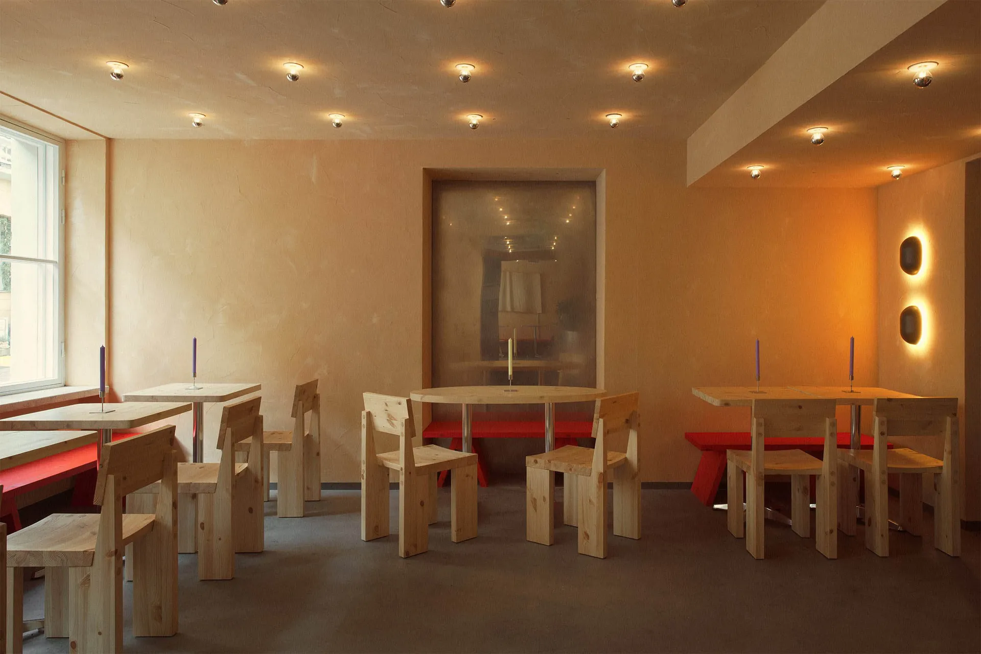 An inviting restaurant with wooden tables and benches, providing ample seating options for guests