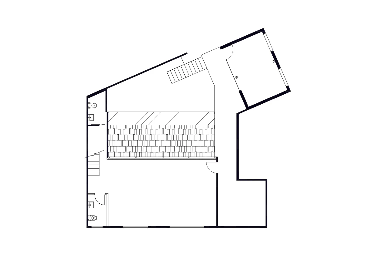 A clean and bright interior space with a staircase leading to another level, featuring white walls and a simple layout