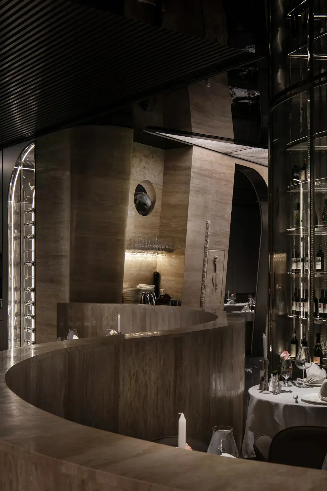 Sophisticated restaurant bar with wine glasses, bottles, and cups on display, inviting atmosphere for fine dining and wine tasting