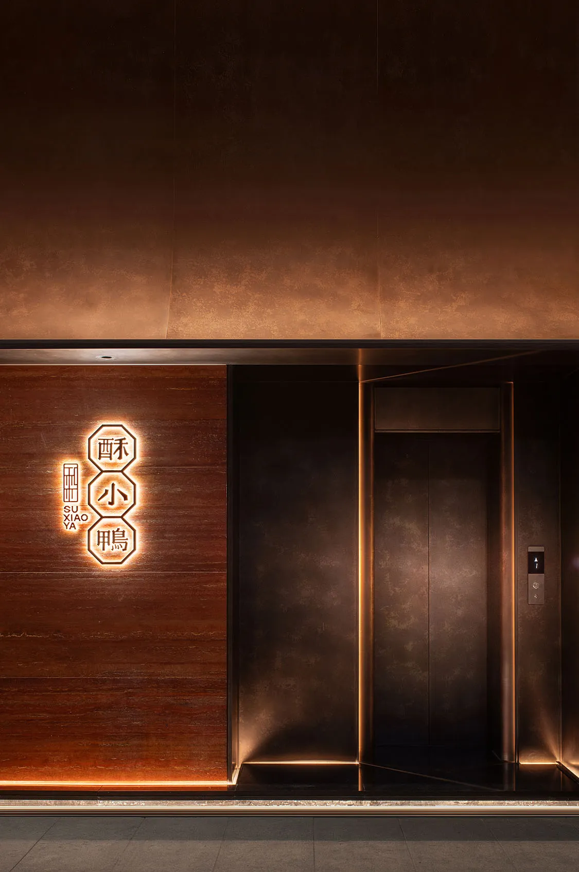 A wooden elevator with Chinese characters on the walls, blending traditional and modern elements in an Asian building