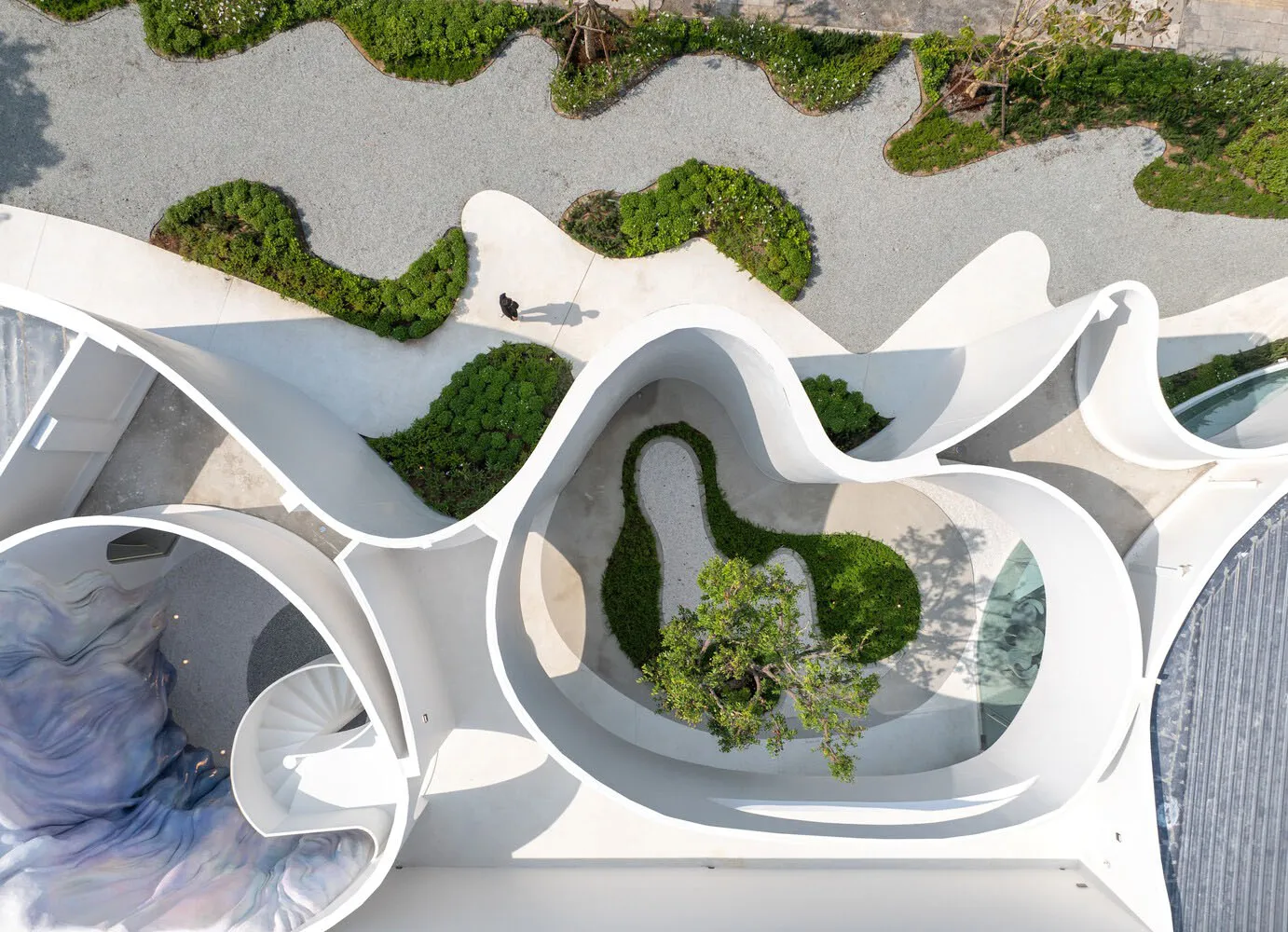 舒適室內空間，融合多種座椅區、盆栽植物與餐桌，周圍環繞各式家具與綠意