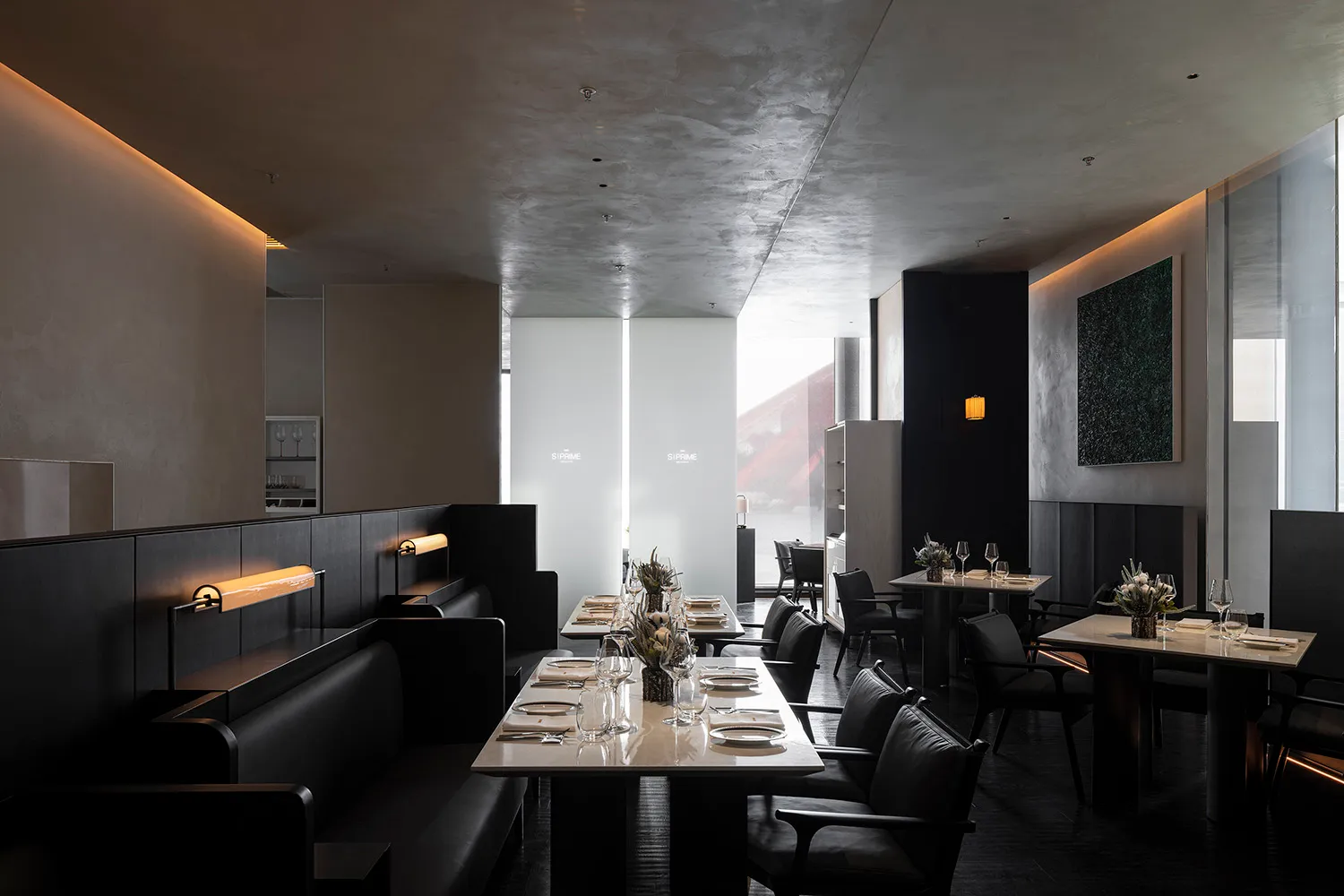 Elegant restaurant interior with dining area, tables, chairs, and wine glasses, set in a comfortable and inviting atmosphere