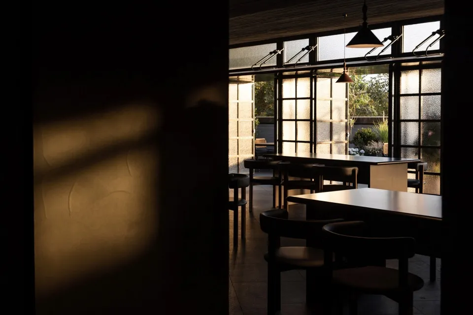 Cozy restaurant interior with stone walls, wooden tables, and comfortable seating for guests