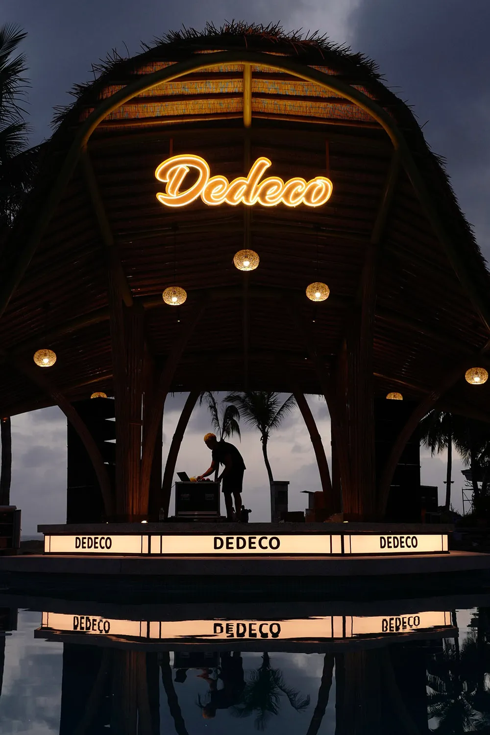 An outdoor venue with a stage and chairs for guests, set in a lively and entertaining atmosphere
