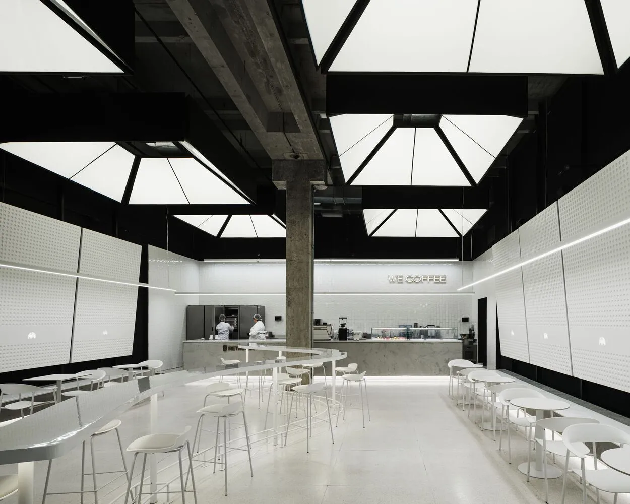 A modern coffee shop interior with multiple tables and chairs, steel, and glass, warm and inviting atmosphere