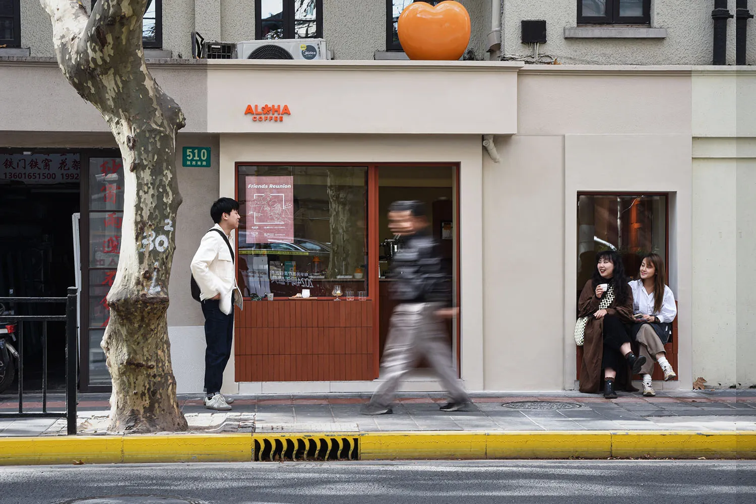A restaurant with a wooden exterior, featuring a mix of brown and white tones, with people walking and dining inside