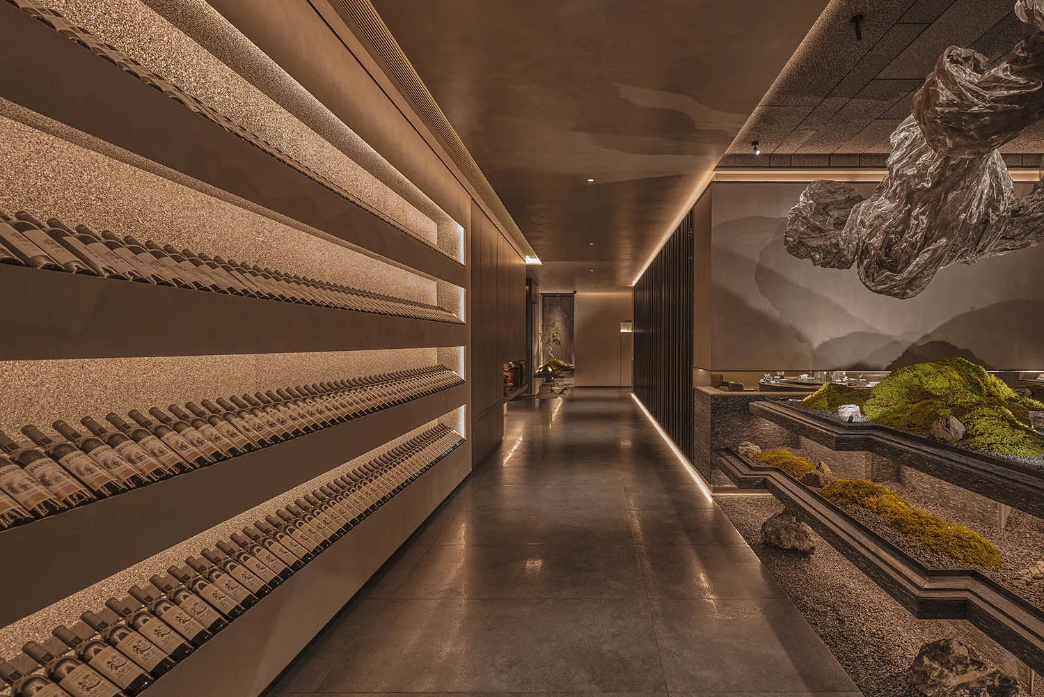 A sophisticated interior design showroom featuring a large display of wine bottles on shelves, creating an eye-catching presentation