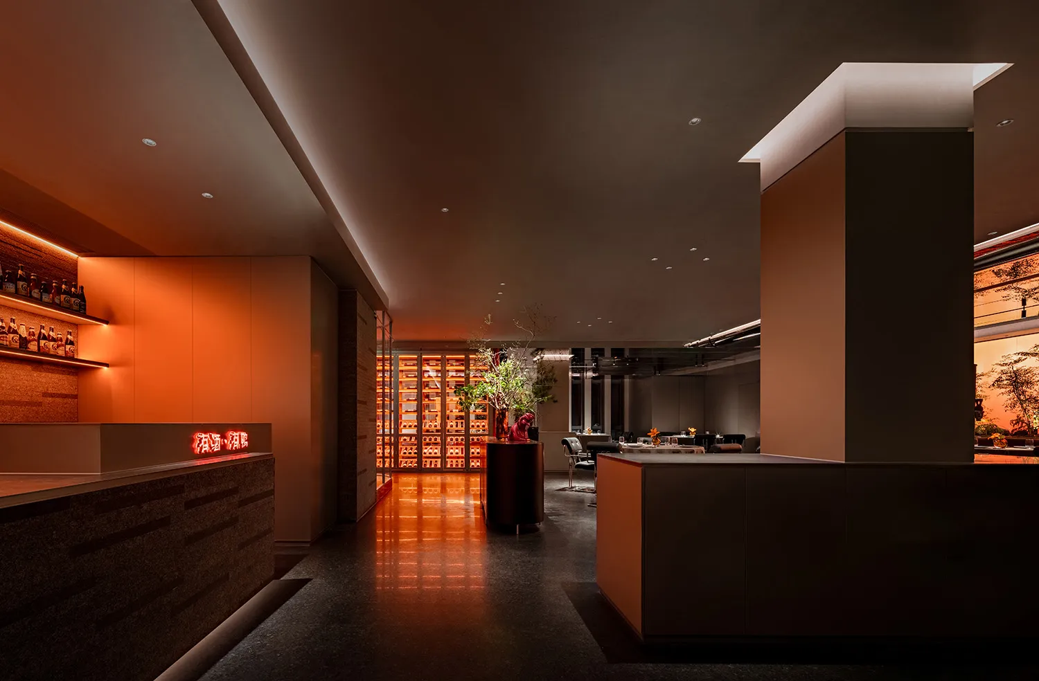 A modern restaurant interior with a large dining area, potted plants, and contemporary walls