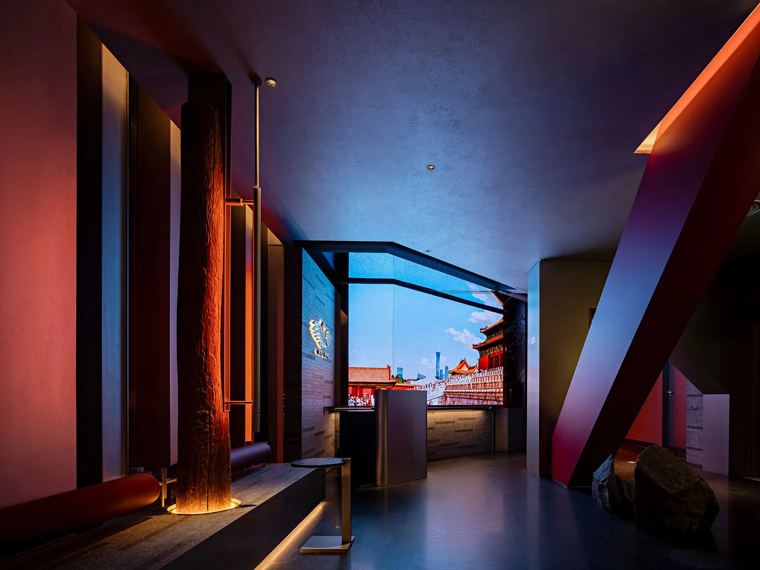 Asian-inspired interior design with a large window showcasing a city skyline, wooden walls, and stone elements