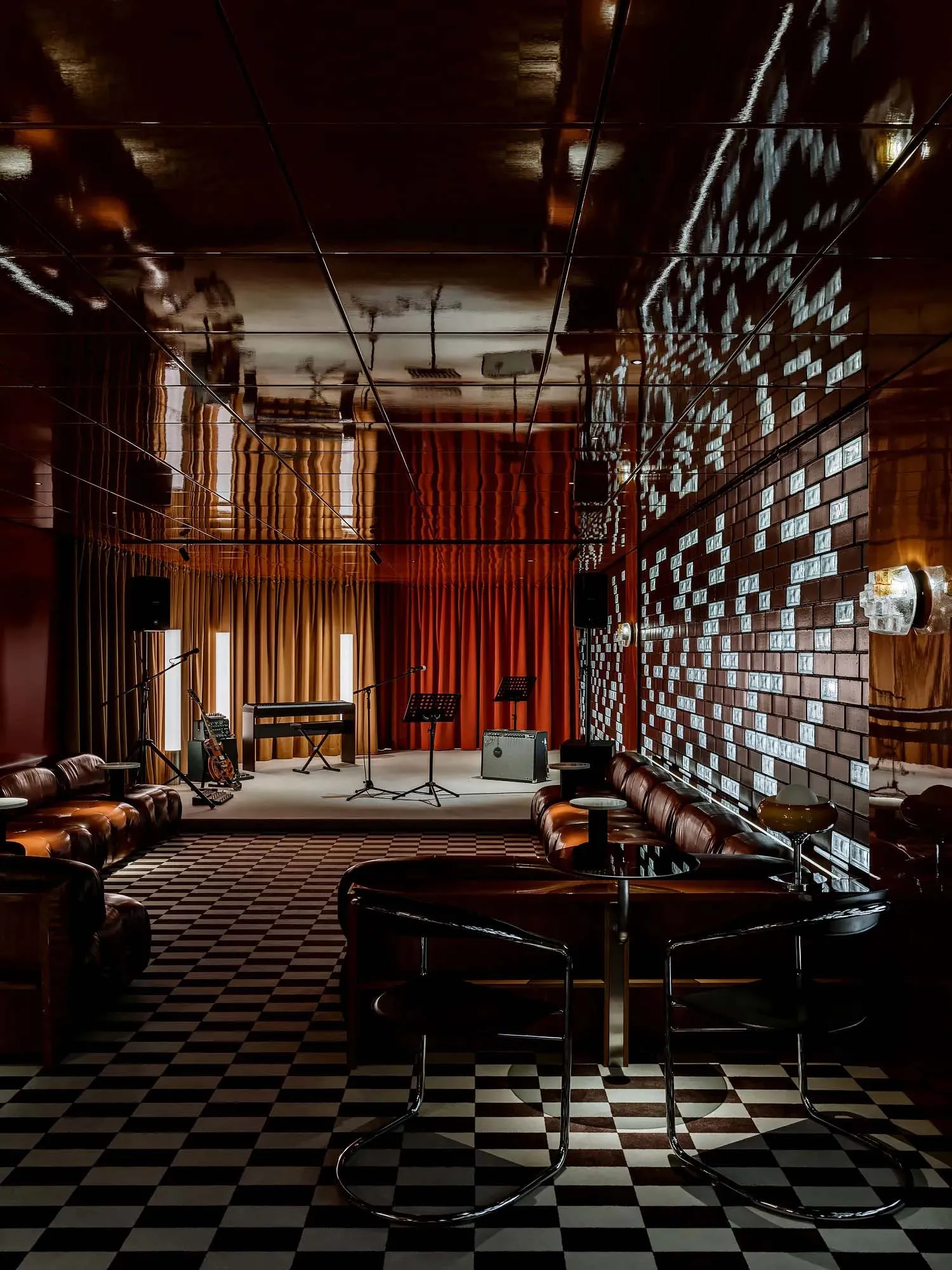 A modern lounge area with a piano, dining table, and chairs, featuring a stylish and elegant atmosphere