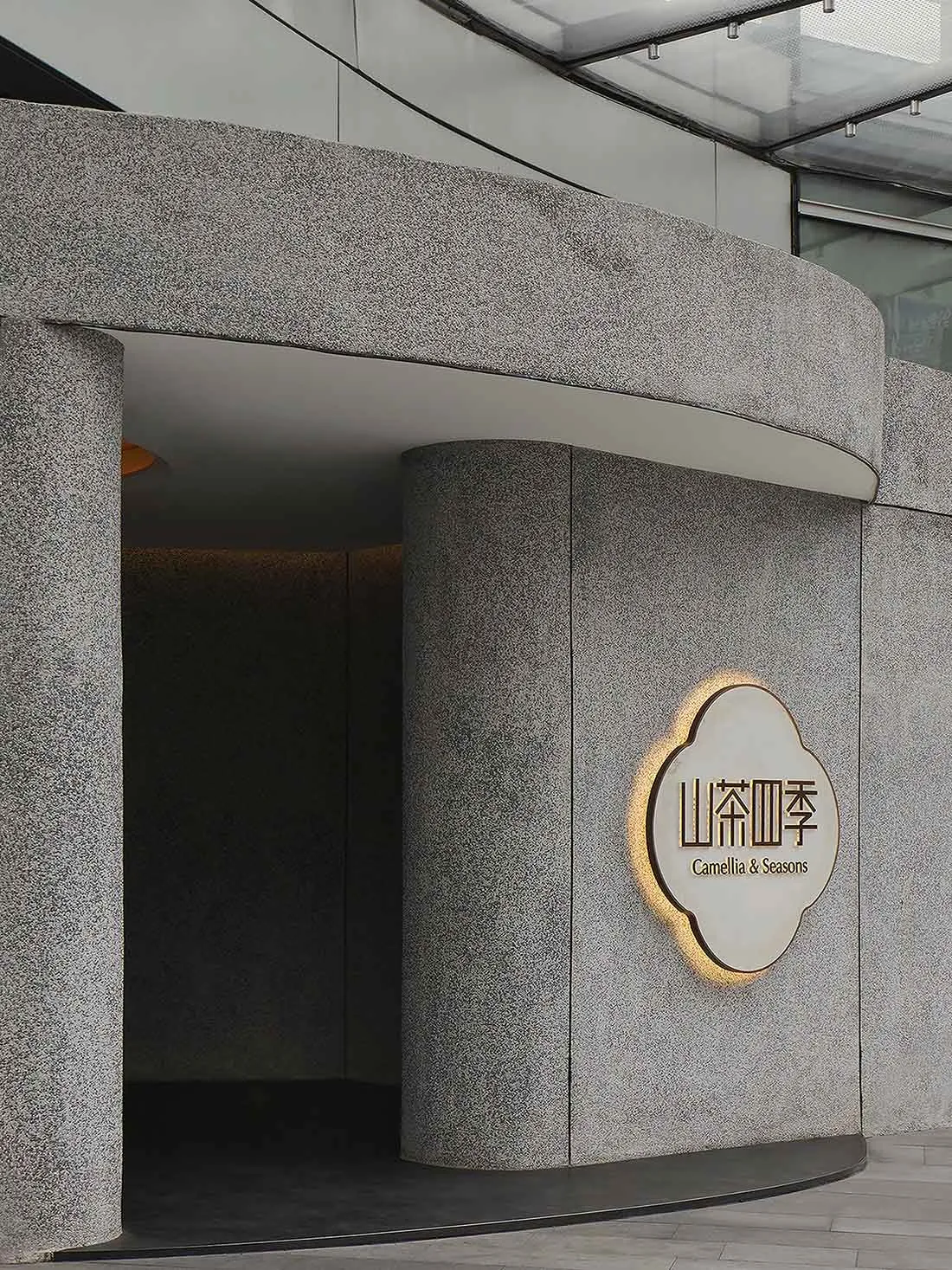 Gray stone hotel entrance with a large sign reading Canelo Seasons, set against a neutral background