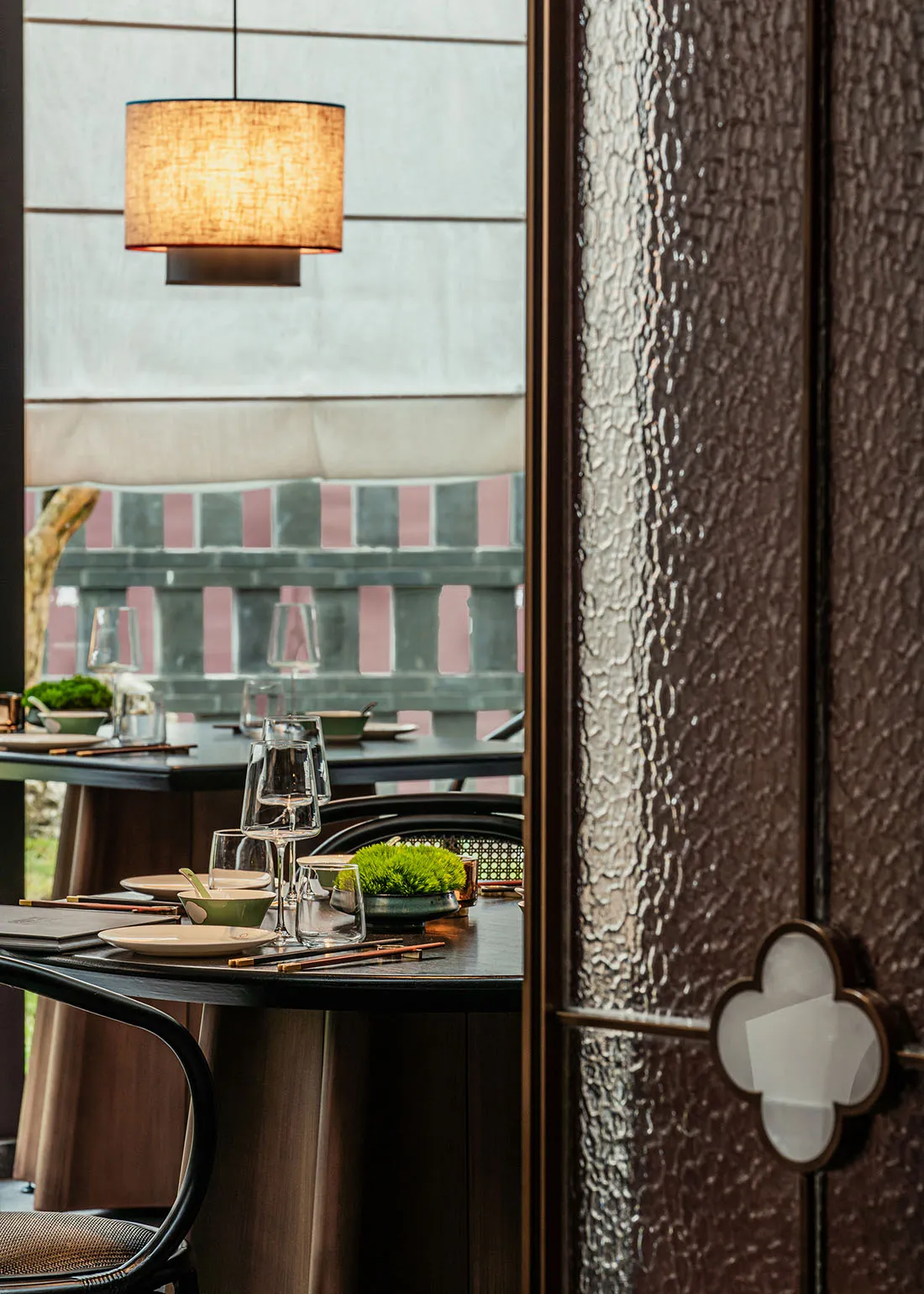 A dining area with a table set for a meal, surrounded by chairs and decorative elements, creating a sophisticated atmosphere