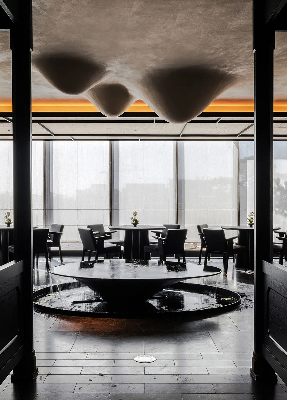 Cozy restaurant dining space with a round table and chairs, modern design, and good lighting
