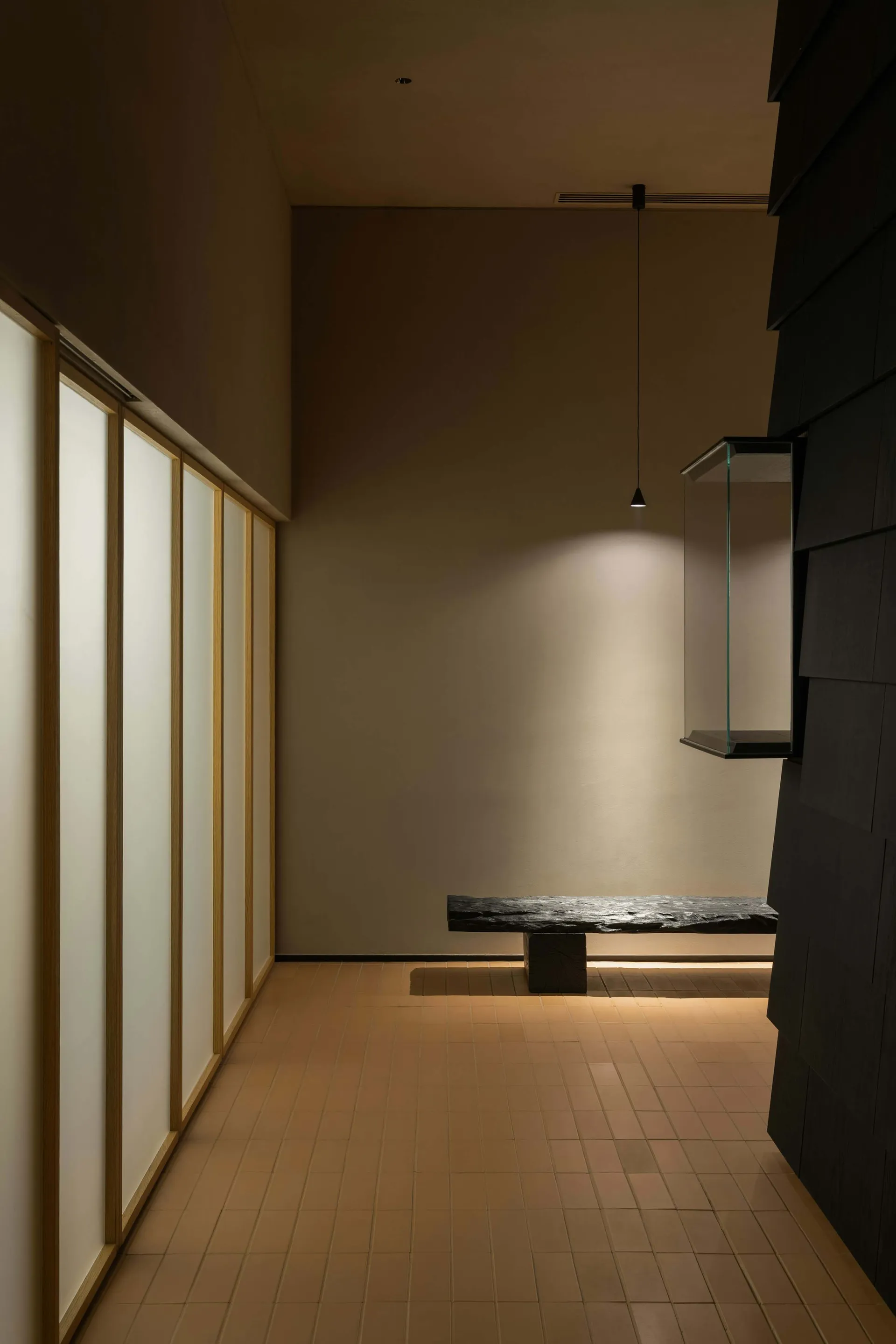 Bright and inviting open office space with glass walls, a bench, and natural light