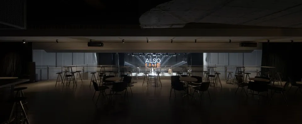 Empty auditorium with a stage and seating areas, suggesting a space for performances or events