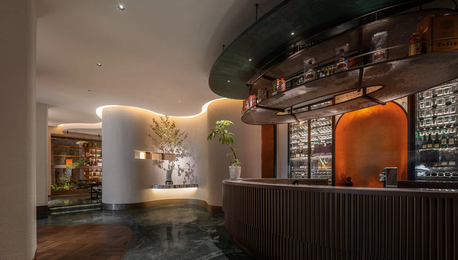 A sophisticated bar area with a counter, wine rack, and potted plants, creating a warm and inviting atmosphere