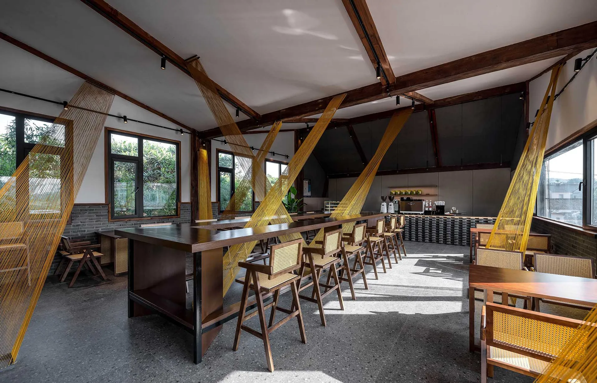 Inviting open concept restaurant with multiple dining tables and chairs, creating a spacious atmosphere for guests to enjoy their meals together