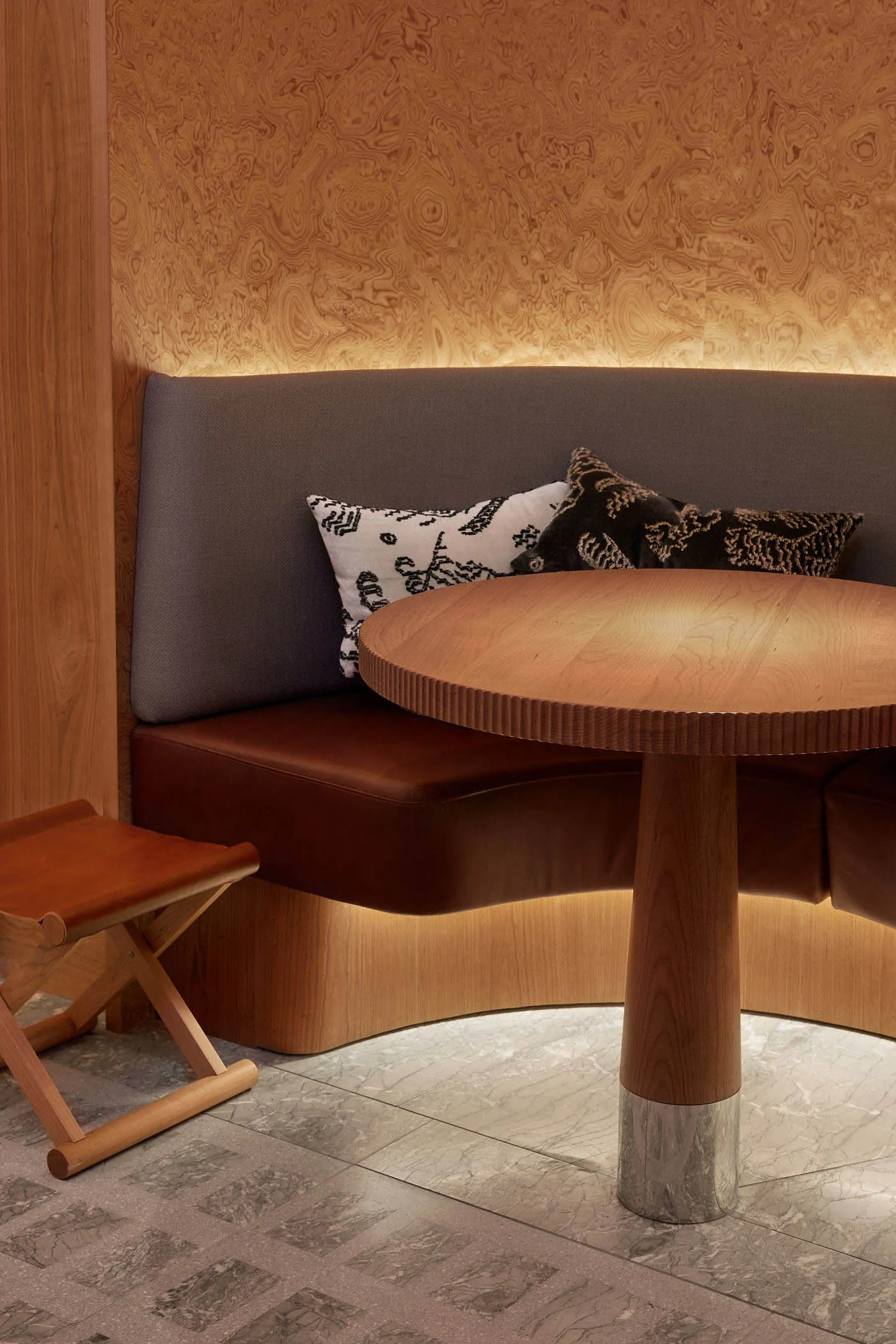 Cozy living space with a sofa, dining table, and chairs, featuring a warm and inviting atmosphere