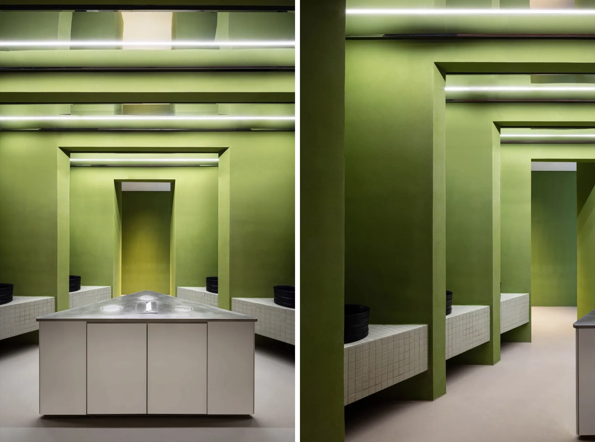 A modern bathroom with green walls, dual sinks, and decorative bowls, showcasing a clean and organized space with a focus on functionality and aesthetics