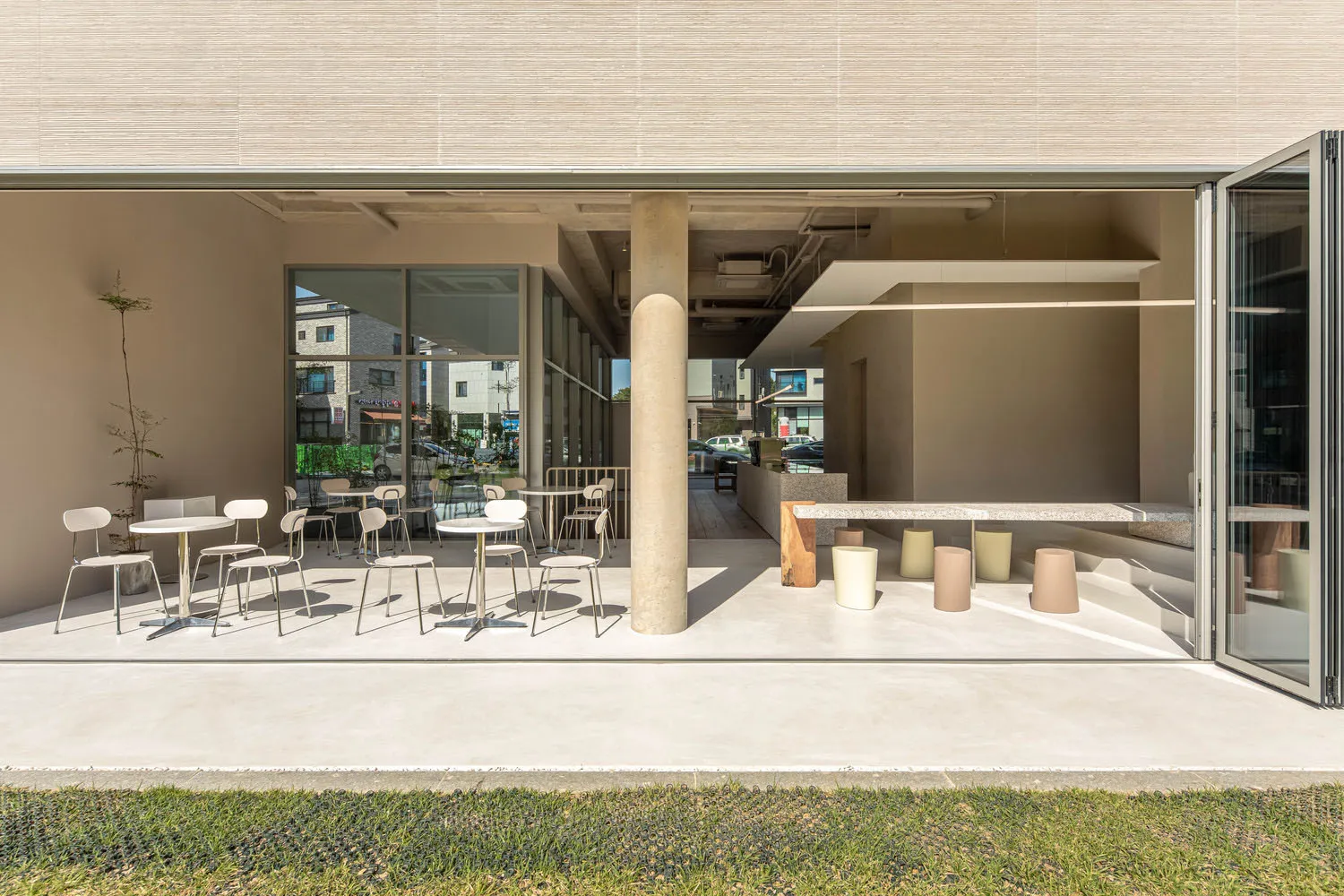 An inviting outdoor dining area with multiple tables and chairs, surrounded by a comfortable and relaxed atmosphere