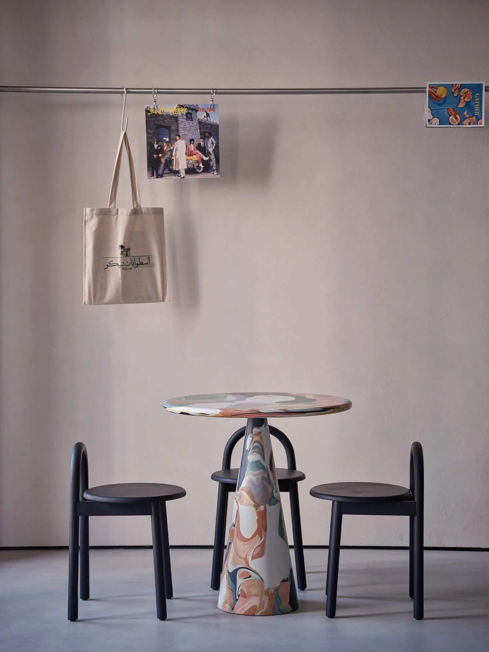 A modern dining space with a unique table and two black chairs, surrounded by a stylish and contemporary atmosphere