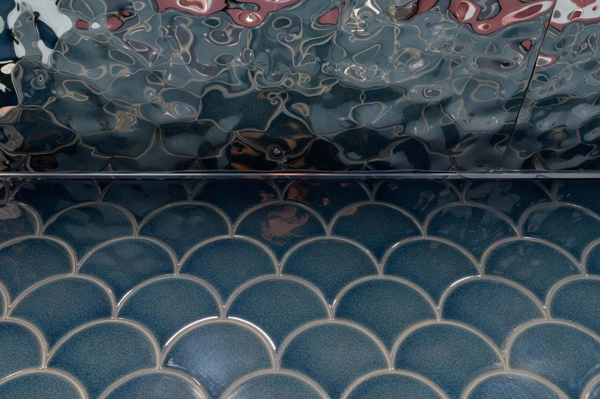 Aqua-colored tile floor with a unique pattern in a bathroom, creating a calm and relaxing atmosphere with a soothing blue color scheme