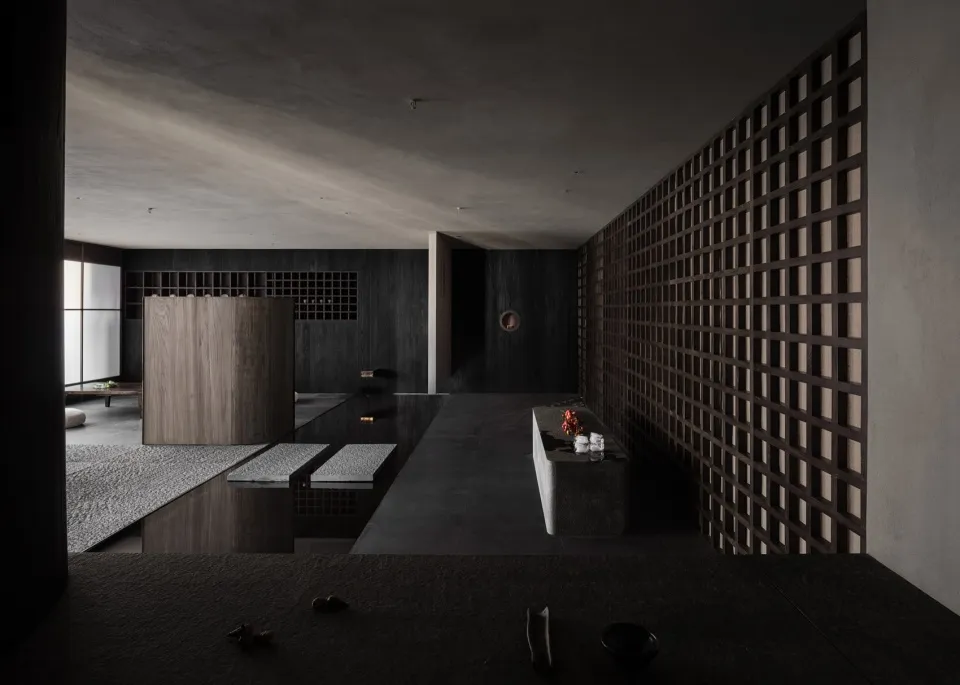 Empty modern kitchen with a dark atmosphere, featuring a sink surrounded by decorative vases and kitchenware