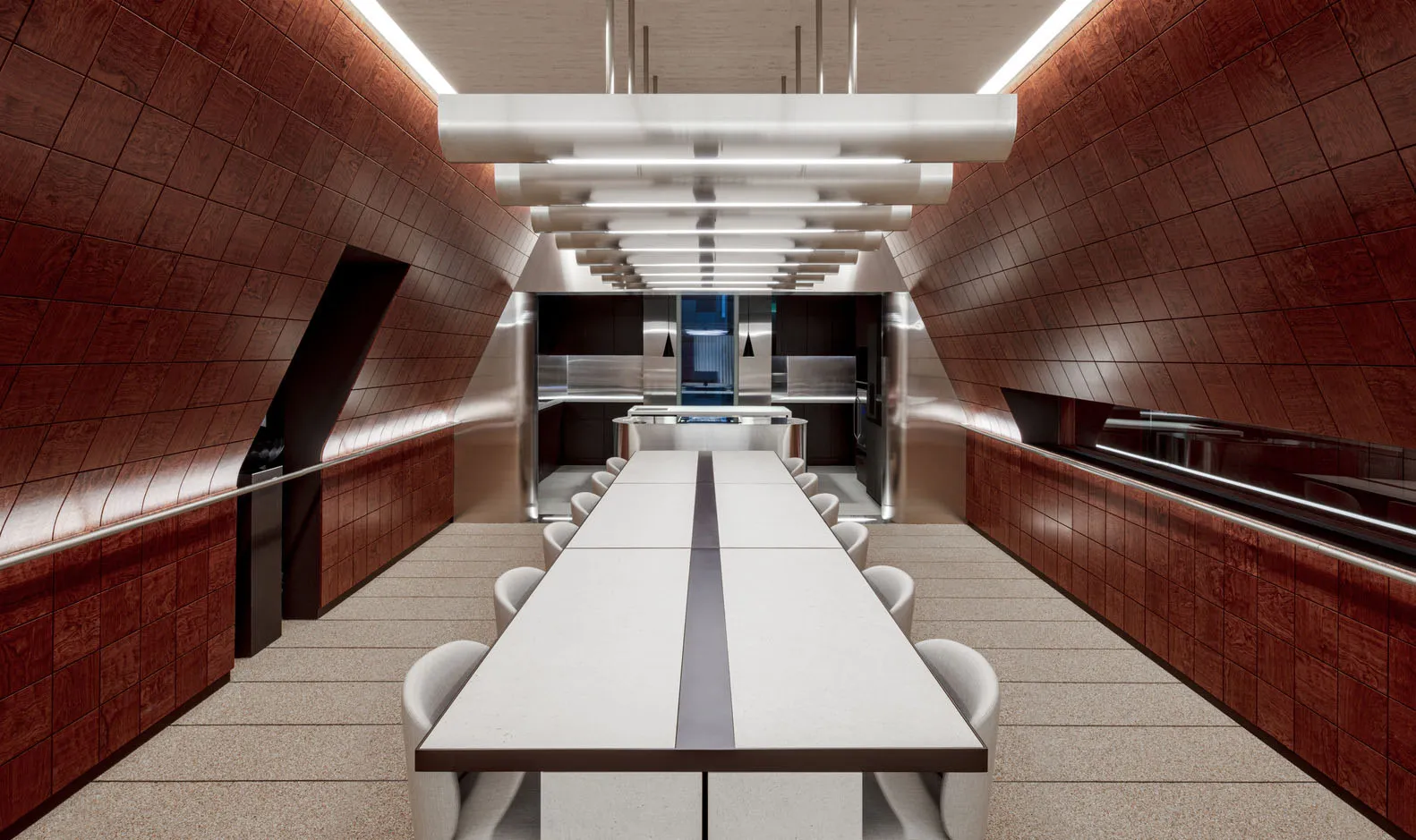 Open modern kitchen and dining area with stainless steel appliances, a dining table, and several chairs, giving off a sleek and contemporary vibe