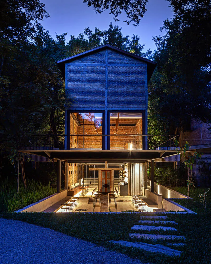 Modern house with a brick exterior, open living area, and patio with comfortable seating arrangement