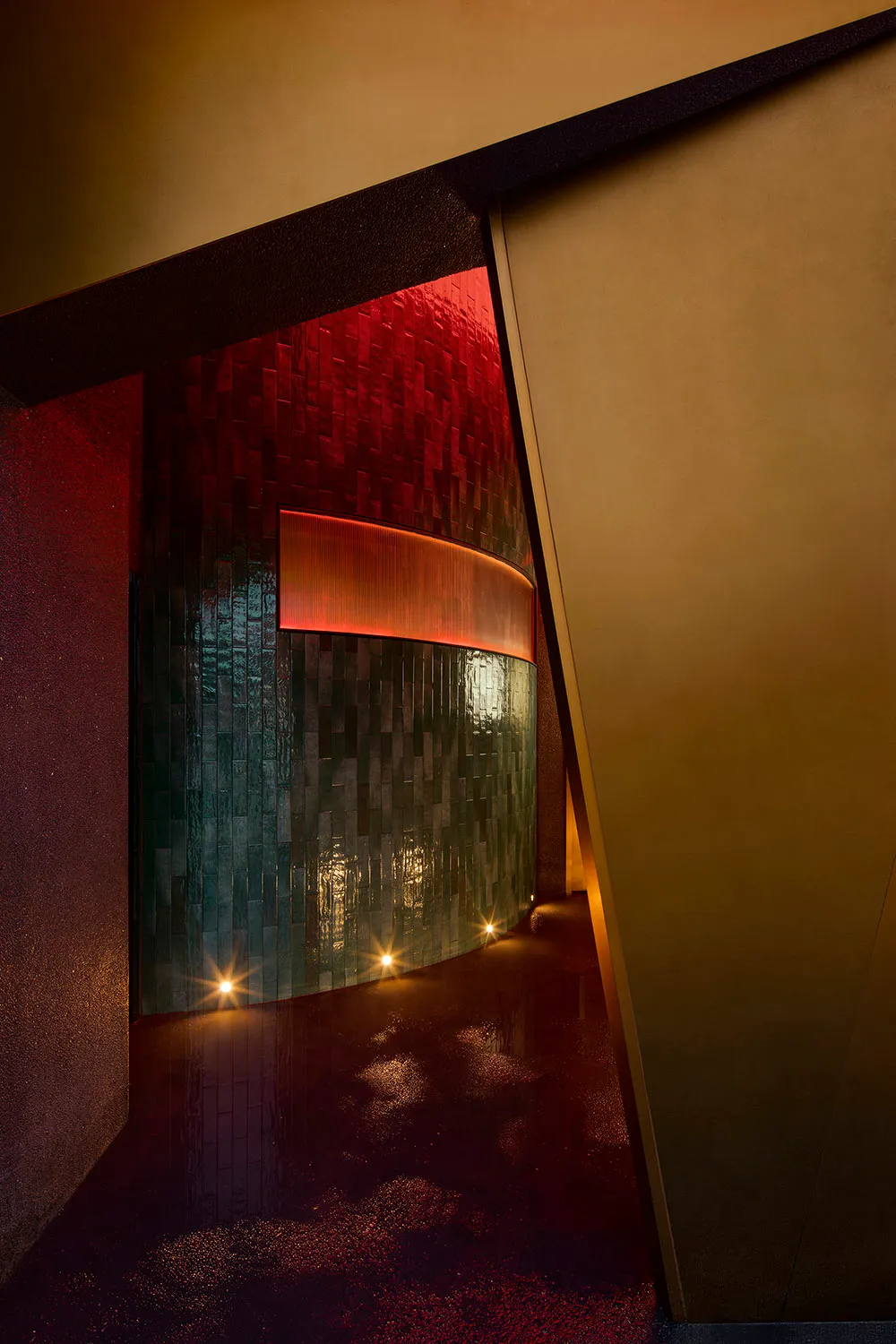 A bathroom with a red wall and a green wall, featuring a red doorway and tile-covered walls in a modern space