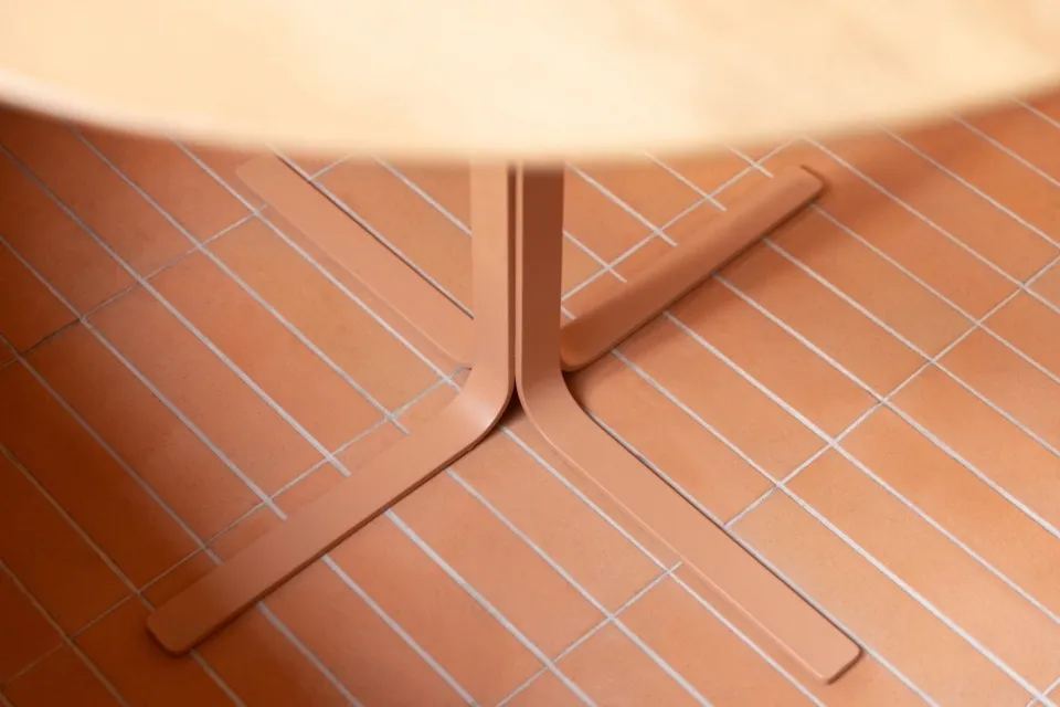 A wooden dining table sits on a patterned tile floor in a warm and inviting room, perfect for gatherings and meals