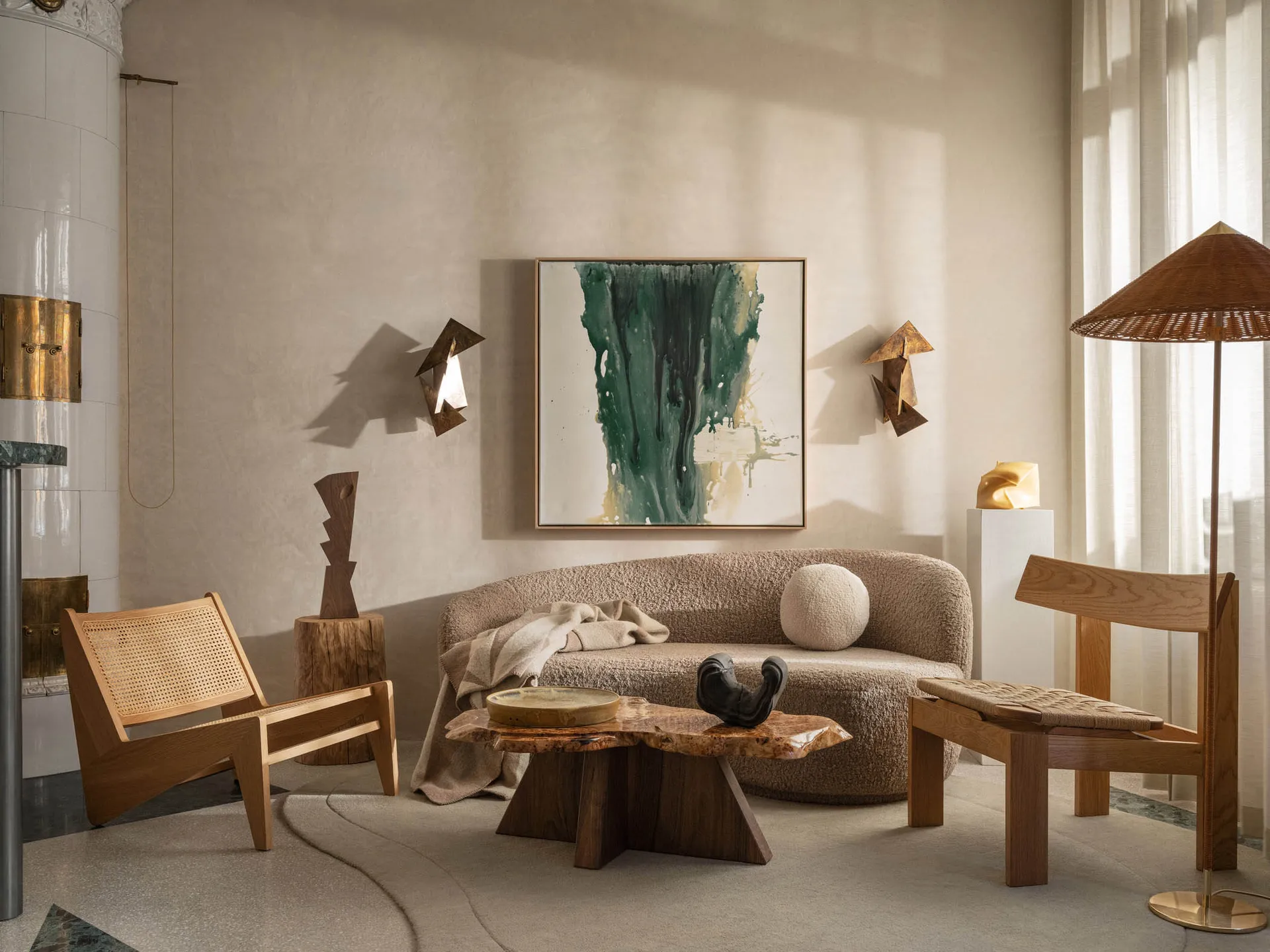 A modern living room with a couch, coffee table, chairs, paintings, and well-lit atmosphere