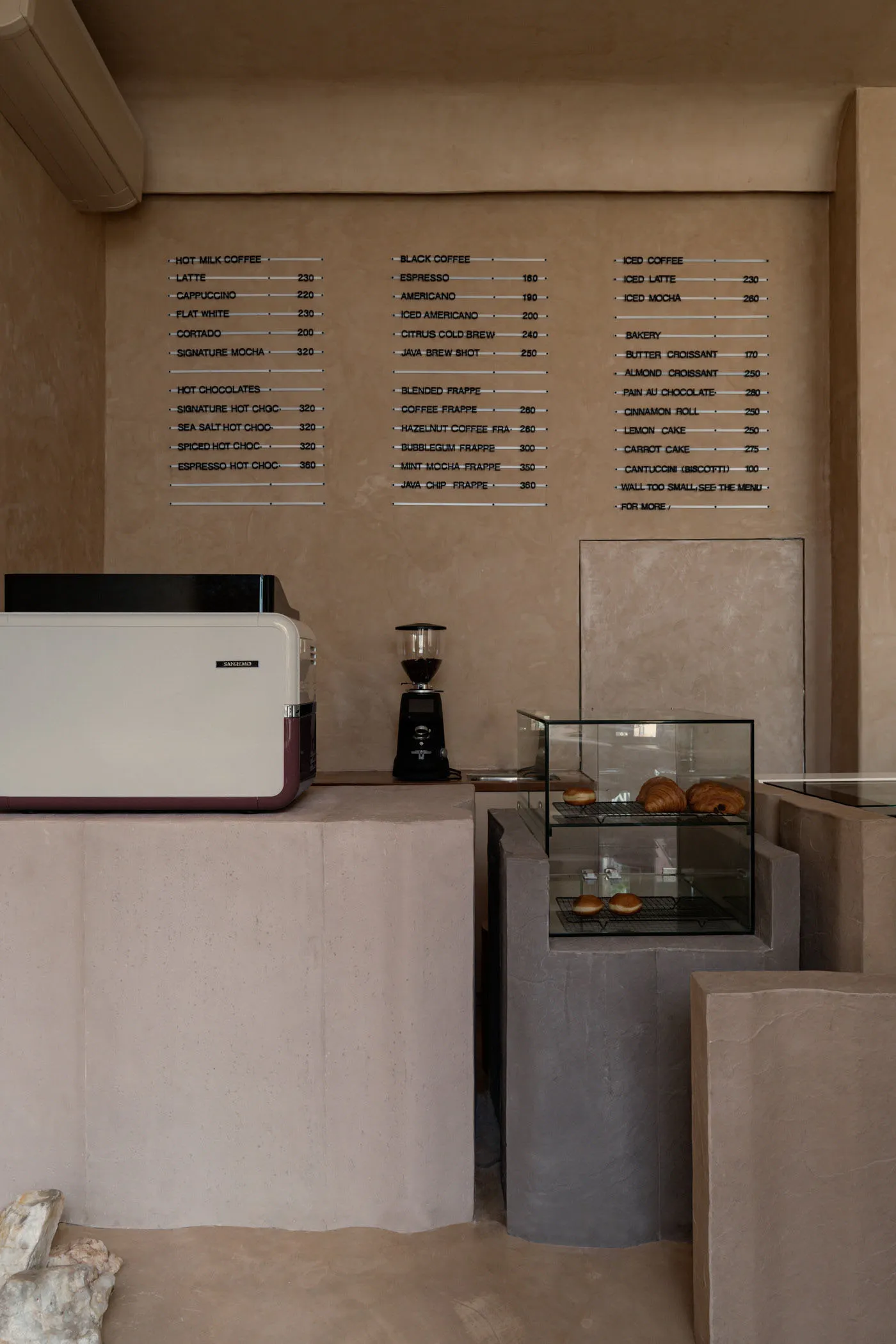 A cozy coffee shop interior with wooden furniture, cups, and a cake on a table, creating a welcoming atmosphere