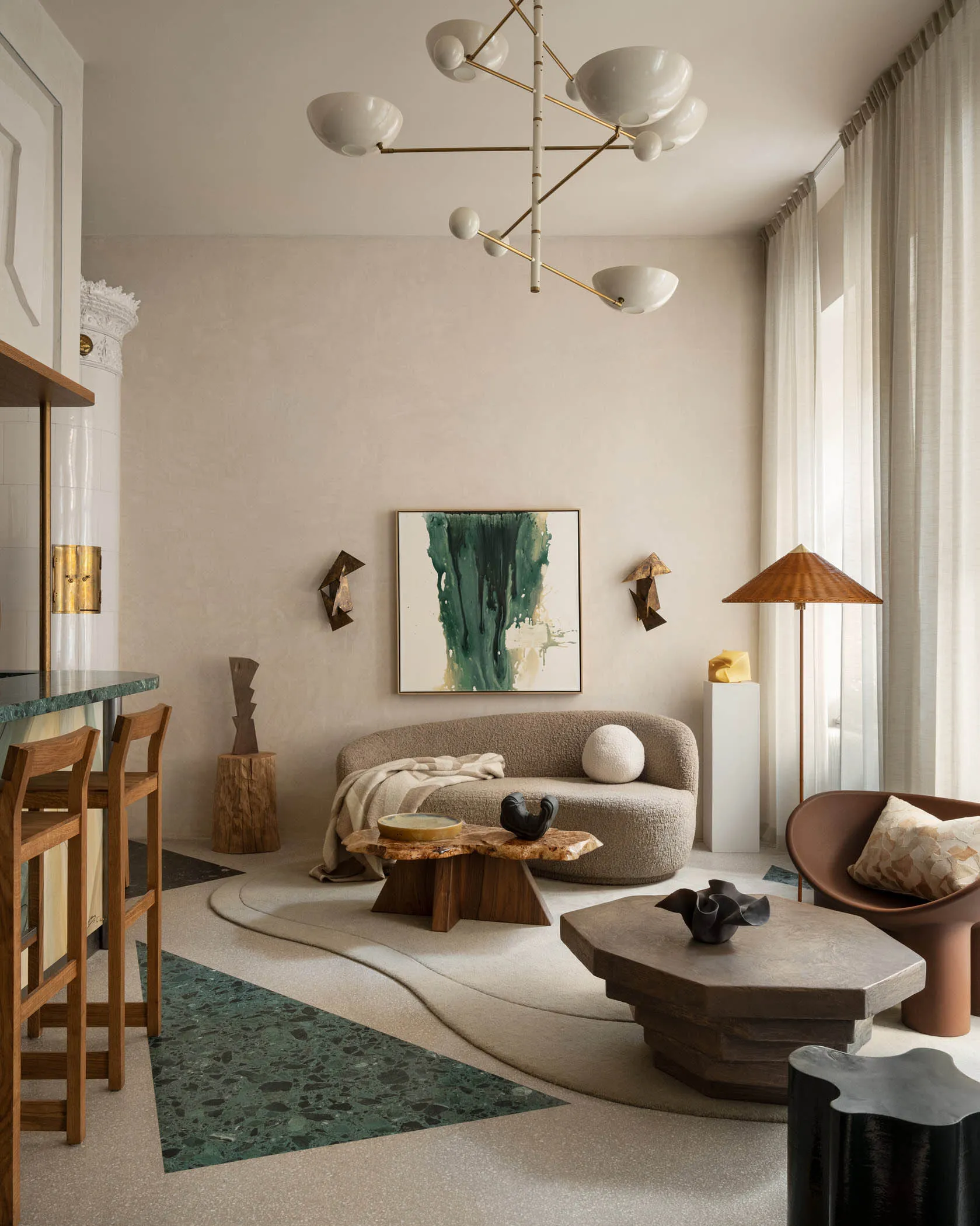 Cozy living area with a couch, chairs, tables, lamps, and decorative items, featuring a combination of wood and metal elements