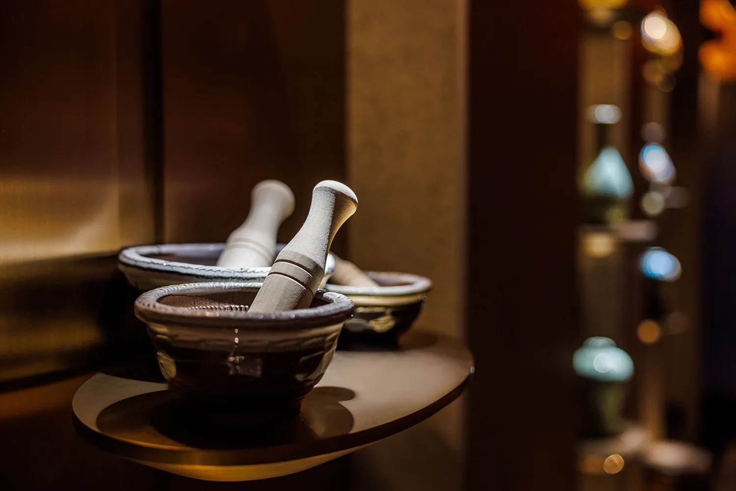 A kitchen area with three bowls on a table, creating a cozy and functional space for cooking and food preparation